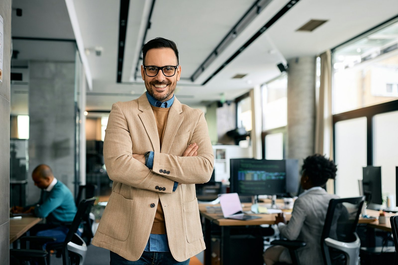 Confident businessman at corporate office looking at camera.